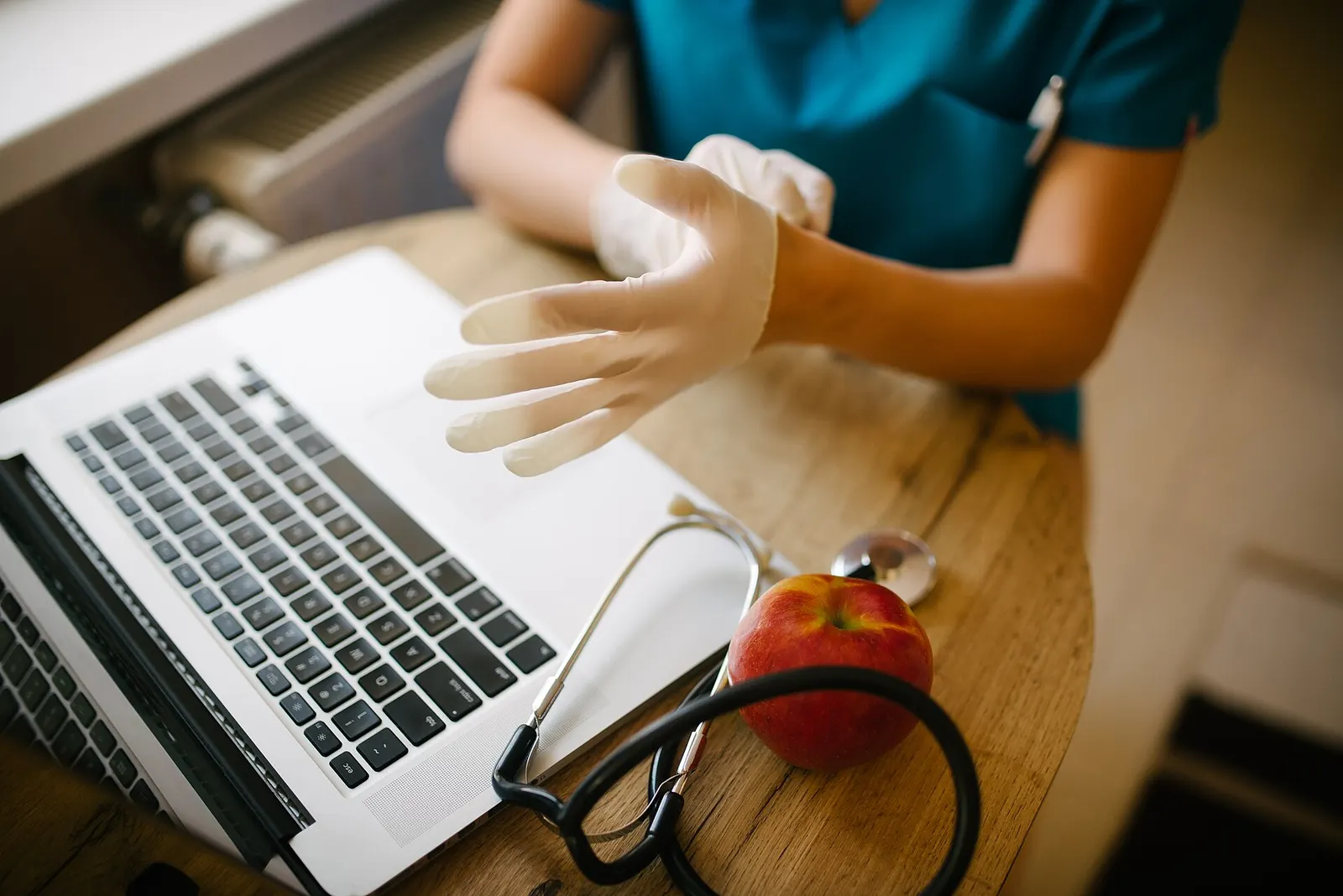 A doctor putting on medical gloves
